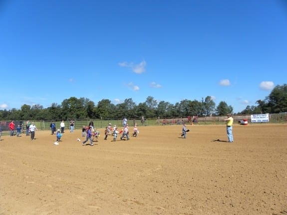 The kids running the stick horse race.